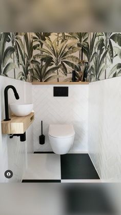 a white toilet sitting in a bathroom next to a wall mounted faucet and sink