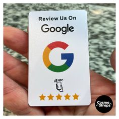 a hand holding up a google sticker with five stars