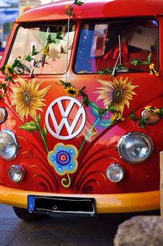 an old vw bus with sunflowers painted on it