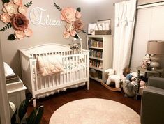 a baby's room with flowers on the wall