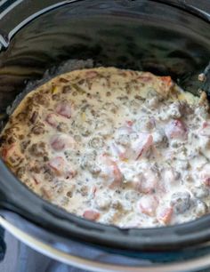 an easy sausage dip in the crock pot with text overlay that says easy sausage dip