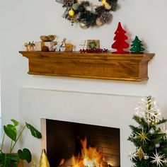 a fireplace with christmas decorations on the mantle