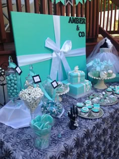 a table topped with blue and white desserts