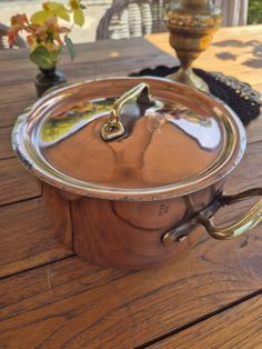 a large pot sitting on top of a wooden table