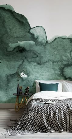 a bedroom with green watercolor paint on the wall