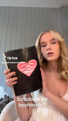 a woman holding up a book in front of her face with the title scrapbook for boyfriends 3