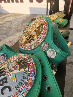 two green boxing gloves sitting on top of each other