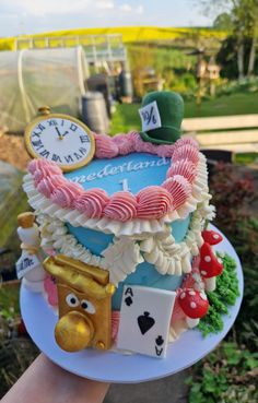 a cake that is on top of a plate in the shape of a clock and other items