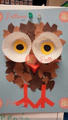 an owl made out of paper on top of a bulletin board