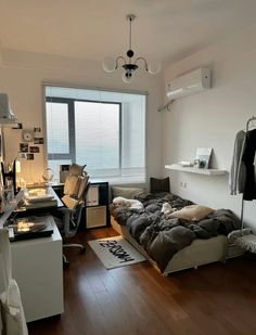 a bedroom with a bed and desk in it