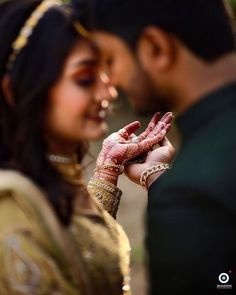 a bride and groom holding their hands together