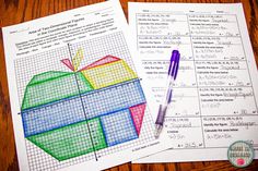 two sheets of graph paper and a pen on a table