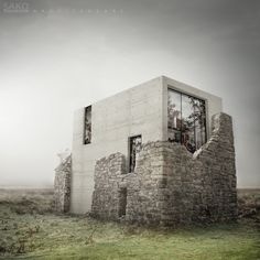 a house made out of bricks sitting on top of a grass covered field