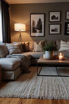 a living room filled with lots of furniture next to a lamp and pictures on the wall