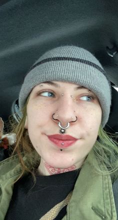 a woman with piercings on her nose and nose