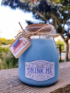 a blue jar filled with liquid sitting on top of a wooden table