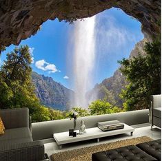 a living room filled with furniture and a large waterfall in the middle of the wall