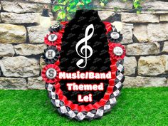 a sign that says music / band themed lei on it in front of a stone wall