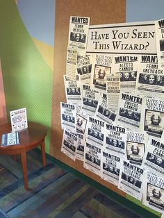 a bulletin board with news paper on it in front of a wall that has been decorated with newspaper clippings