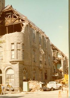 an old building that has been demolished and is being worked on by the construction workers