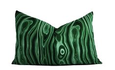 a green and black pillow with wavy lines on the front, sitting on a white background