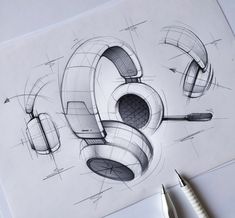 a drawing of headphones on top of a piece of paper next to a pen