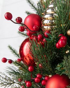 red ornaments and greenery on a christmas tree