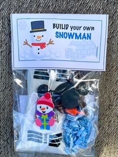 a package of snowman magnets on the ground