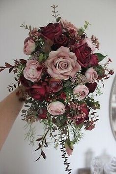 a woman holding a bouquet of flowers in her hand