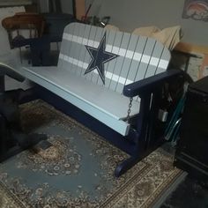 a bench with a star painted on it in the middle of a room filled with other furniture