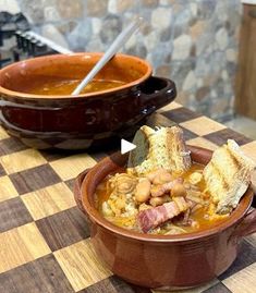 a brown bowl filled with soup sitting on top of a wooden table