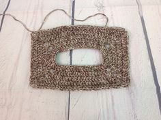 a crocheted square is sitting on the floor