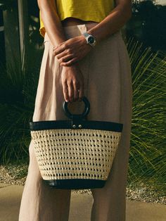 Handmade in Peru by local artisans, this open weave basket bag is your new warm weather essential. (Oh, and did we mention it's made in a woman-owned factory?) The leather-covered ring handle and contrasting leather trim add a polished touch, making this the perfect chic accessory for your laid-back summer looks. (This one comes in Jet Black/Natural.) * All pieces are subject to slight differences in shape, size, and color, which are natural (and part of the charm) of a handmade product. Measure Weave Basket, Ring Handle, Basket Bag, Open Weave, Chic Accessories, Local Artisans, New Tops, Leather Cover, Jet Black