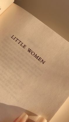 an open book with the words little women written on it