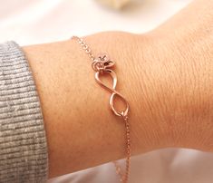 Infinity symbol represents continuous connection, eternity and everlasting love. Personalize this rose gold infinity bracelet by adding the initials of loved one.   Silver infinity bracelet:  https://www.etsy.com/ca/listing/197354727/sterling-silver-infinity-bracelet?click_key=95139ec8199a44b7fdc5032d6bdb60da6c91e12d%3A197354727&click_sum=66eaad64&ref=shop_home_active_2 Gold infinity bracelet:  https://www.etsy.com/ca/listing/169176101/infinity-bracelet-with-personalized?click_key=45721134b7943d Rose Gold Infinity Bracelets For Friendship, Infinity Rose Gold Bracelet For Mother's Day, Rose Gold Infinity Bracelet For Mother's Day, Personalized Infinity Rose Gold Jewelry, Personalized Rose Gold Infinity Jewelry, Dainty Rose Gold Infinity Jewelry, Elegant Infinity Bracelet For Best Friend, Rose Gold Infinity Bracelet Gift, Rose Gold Bracelet For Mother's Day Best Friend Gift