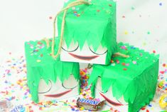 two bags with green hair and sprinkles on them, one bag has a candy bar in it