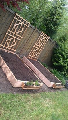 several raised garden beds in the middle of a yard