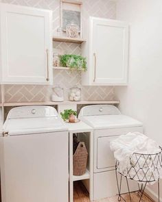 a white washer and dryer sitting in a laundry room next to each other