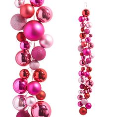 pink and red ornaments are hanging from the side of a tall pole with white background