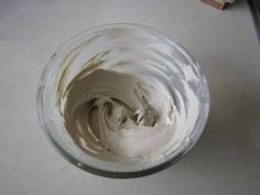 a bowl filled with whipped cream sitting on top of a counter