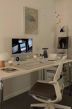 a white desk with a computer on top of it