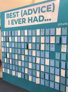 a large blue and white calendar on display in a room with people standing around it