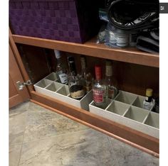 an open cabinet filled with liquor bottles