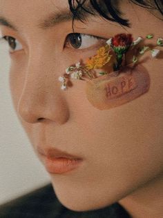 a man with his face covered in stickers and the word hope written on it