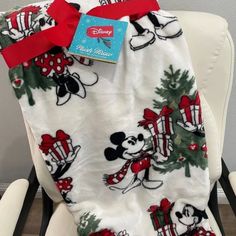 the mickey mouse christmas blanket is sitting on a chair