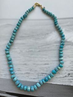 This necklace is made with beautiful faceted blue opal and it would make a great addition to your necklace stack. The necklace looks great layered with other pieces or worn on its own.  *The necklace measures approximately 18 3/4 inches long including the clasp.  * this is a Graduated strand, the beats are larger in the center and get smaller as it gets closer to the clasp * Gold filled is an alternative to solid gold. But be aware that it is not solid gold and therefore can still tarnish. Pleas Turquoise Faceted Rondelle Necklaces, Blue Oval Necklace With Faceted Beads, Turquoise Faceted Rondelle Necklace, Blue Amazonite Single Strand Beaded Necklaces, Blue Single Strand Amazonite Beaded Necklaces, Handmade Blue Amazonite Beaded Necklace, Unique Blue Necklaces With Faceted Beads, Blue Amazonite Single Strand Necklace, Blue Amazonite Round Bead Necklaces