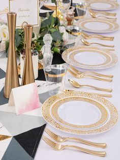 the table is set with gold and white plates, silverware, napkins and place cards