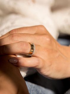 a woman's hand with a ring on her finger