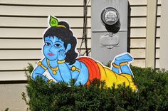 an image of a painted avatar on the side of a house in front of a mailbox