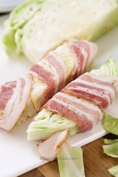 ham and lettuce wrapped in strips on a cutting board next to a knife